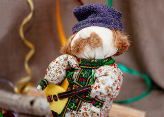 a rag doll man with a mustache and a guitar