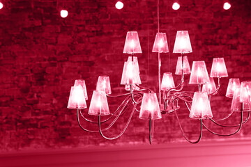 Big vintage electric lamps in the cafe on bricks wall background.
