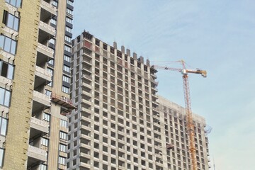 Fototapeta premium Crane and building construction site. Industry modern new civil house business. Concept of development improvement town. Architecture planning of a city. Renovation project. Residential area