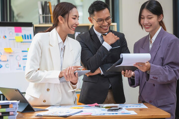 Marketing, Finance, Accounting, Planning, The company's team of marketers analyze the company's profits using laptop computer graphs and calculators, and tablets.Business concept