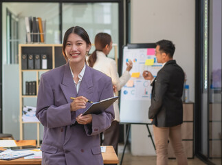 Marketing, Financial, Accounting, Planning, Asian businesswoman team leader with beautiful leaves smiles showing joy after successful company work.