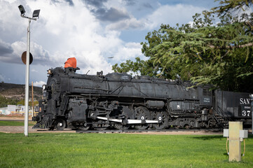 Old steam train machine exposed in a town in the United States