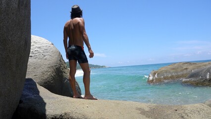 40 years old man arrives to the beach in the Caribbean sea ocean - relax physical and mental well-being during the summer holidays in Colombia Tayrona park  Santa Marta 