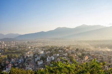 Panoramic view of Kathmandu valley Neoal from a hill at sunset. Blue sky as copy space. A light...