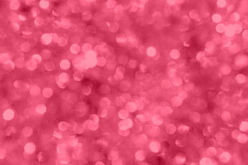 Trendy viva magenta color of 2023. Christmas background. Blurred defocused red lights.
