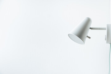 White wall lamp on white wall background. Saving energy. Living during blackout concept. Copy space for a free text. Mockup for interior design project