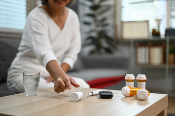 Shot of elderly woman taking daily medicine. Elderly healthcare, pharmaceutical concept