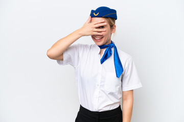 Airplane blonde stewardess woman isolated on white background covering eyes by hands and smiling