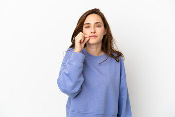 Young caucasian woman isolated on white background showing a sign of silence gesture