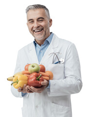 Smiling nutritionist holding fresh vegetables and fruit