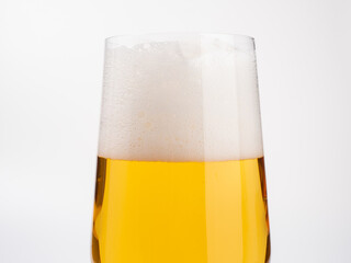 Glass of beer on a white background. A glass of light beer with foam.