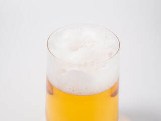 Glass of beer on a white background. A glass of light beer with foam.