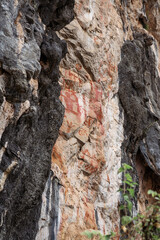 Close up view ancient Aboriginal rock paintings of hunters at Zuojiang Huashan Rock art scenic...