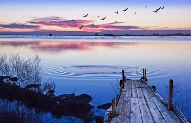 Foto op Plexiglas embarcadero de madera en el lago con el atardecer © kesipun