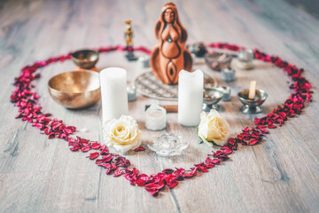 Beautiful altar with rose petals and goddess statuette. ceremony space.