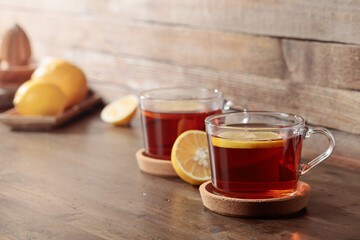 Tea with lemon on a wooden table.
