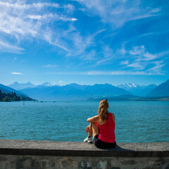 Traveler woman looking at beautiful lake and alps mountain- Switzerland