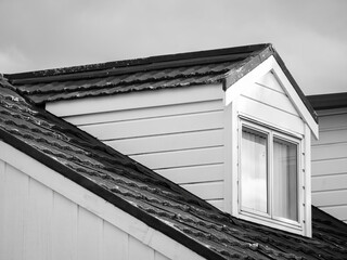 White gable roof dormer loft with window.