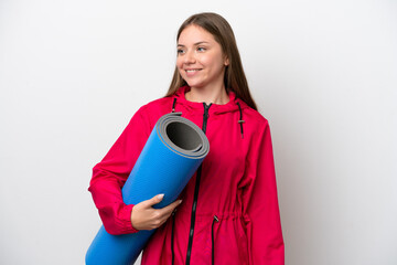 Young sport woman going to yoga classes while holding a mat
