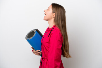 Young sport woman going to yoga classes while holding a mat
