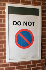 Sign saying DO NOT with a No Entry style round sign below. Authoritarian or dystopian message....