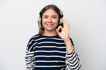 Telemarketer caucasian woman working with a headset isolated on white background showing ok sign with fingers