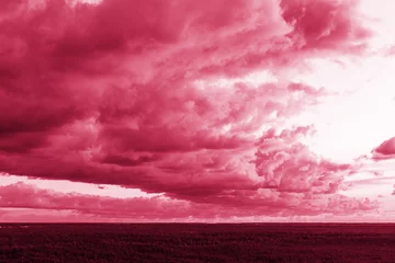 Trendy color of the year 2023. Sky with rain clouds toned in viva magenta color.sky abstract background, beautiful cloudscape, on the heaven, view over white fluffy clouds, freedom concept