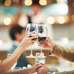 Red wine, hands and date with a couple toast in a restaurant for the celebration of an anniversary. Hospitality, dating and romance with a man and woman drinking alcohol in cheers for fine dining