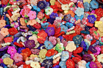 Fototapeta na wymiar Japanese hand made flowers made from colourful fabric - handmade crafts