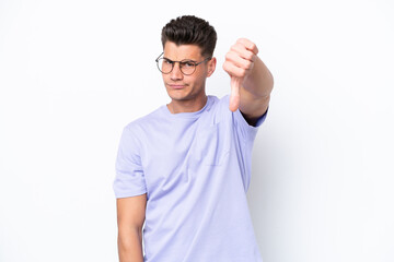 Young caucasian man isolated on white background showing thumb down with negative expression