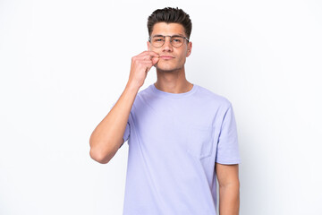 Young caucasian man isolated on white background showing a sign of silence gesture