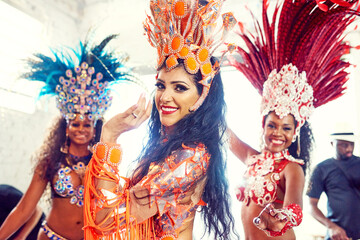 Brazil, portrait and carnival with a woman friends outdoor to dance during a festival, event or celebration. Party, rio de janeiro and fashion with a female and friend group dancing for tradition