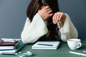 Woman tired in front of the work desk - obrazy, fototapety, plakaty