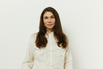 Obraz premium portrait of a beautiful happy attractive adult woman in a white shirt on a white background