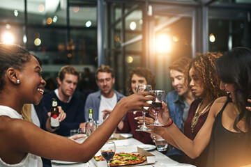 Friends, party and toast with wine for celebration, new year dinner feast and happy with social gathering and friendship. Men, women and food with alcohol drink, pizza and beer to celebrate together.