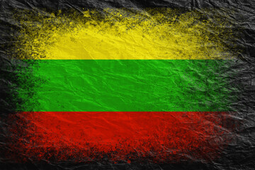 Flag of Lithuania. Flag is painted on black crumpled paper. Paper background. Copy space. Textured background