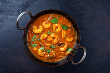 Traditional spicy Indian prawn Madras curry Rogan Josh with king prawns served as top view in a korei bowl with copy space - obrazy, fototapety, plakaty