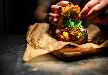 Chefs hand open and cooking burger with beaf and vegetables