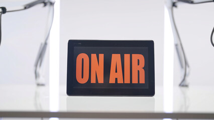 On Air Podcast studio sign on white table background