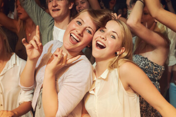 Rock, dance night and friends at a concert, disco event or band performance in the crowd. Happy party, music smile and portrait of dancing women at a rave music festival, show energy and celebration