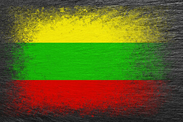 Flag of Lithuania. Flag is painted on black slate stone. Stone background. Copy space. Textured background