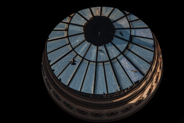 Pigeons fly over the dome of the cathedral, under the ceiling