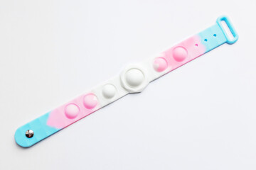 Pop it fidget toy. Multi-colored anti-stress toy with a wing shape on a white background