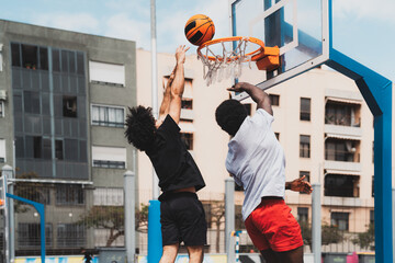 Young men playing basketball outdoor - Urban sport lifestyle concept