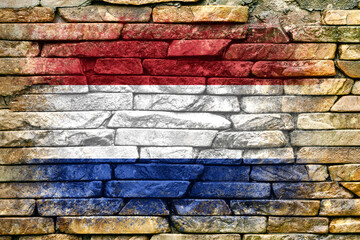 Fototapeta premium Flag of Netherlands. Flag is painted on a stone wall. Stone background. Copy space. Textured background
