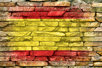 Flag of Spain. Flag is painted on a stone wall. Stone background. Copy space. Textured background