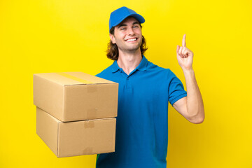 Fototapeta na wymiar Delivery handsome man isolated on yellow background showing and lifting a finger in sign of the best