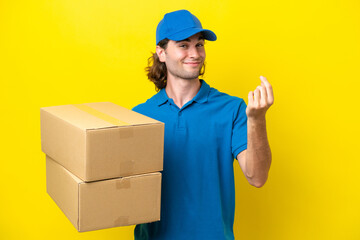 Delivery handsome man isolated on yellow background making money gesture