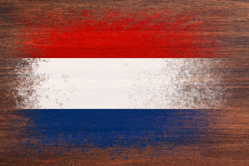 Flag of Netherlands. Flag is painted on a wooden surface. Wooden background. Plywood surface. Copy space. Textured background