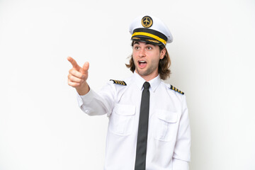 handsome Airplane pilot isolated on white background pointing away